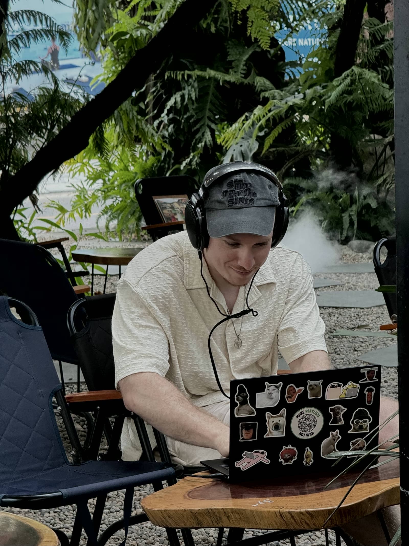 Finch Bergling with headphones on, working on a laptop